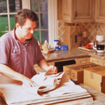 man packing plates in the kitchen